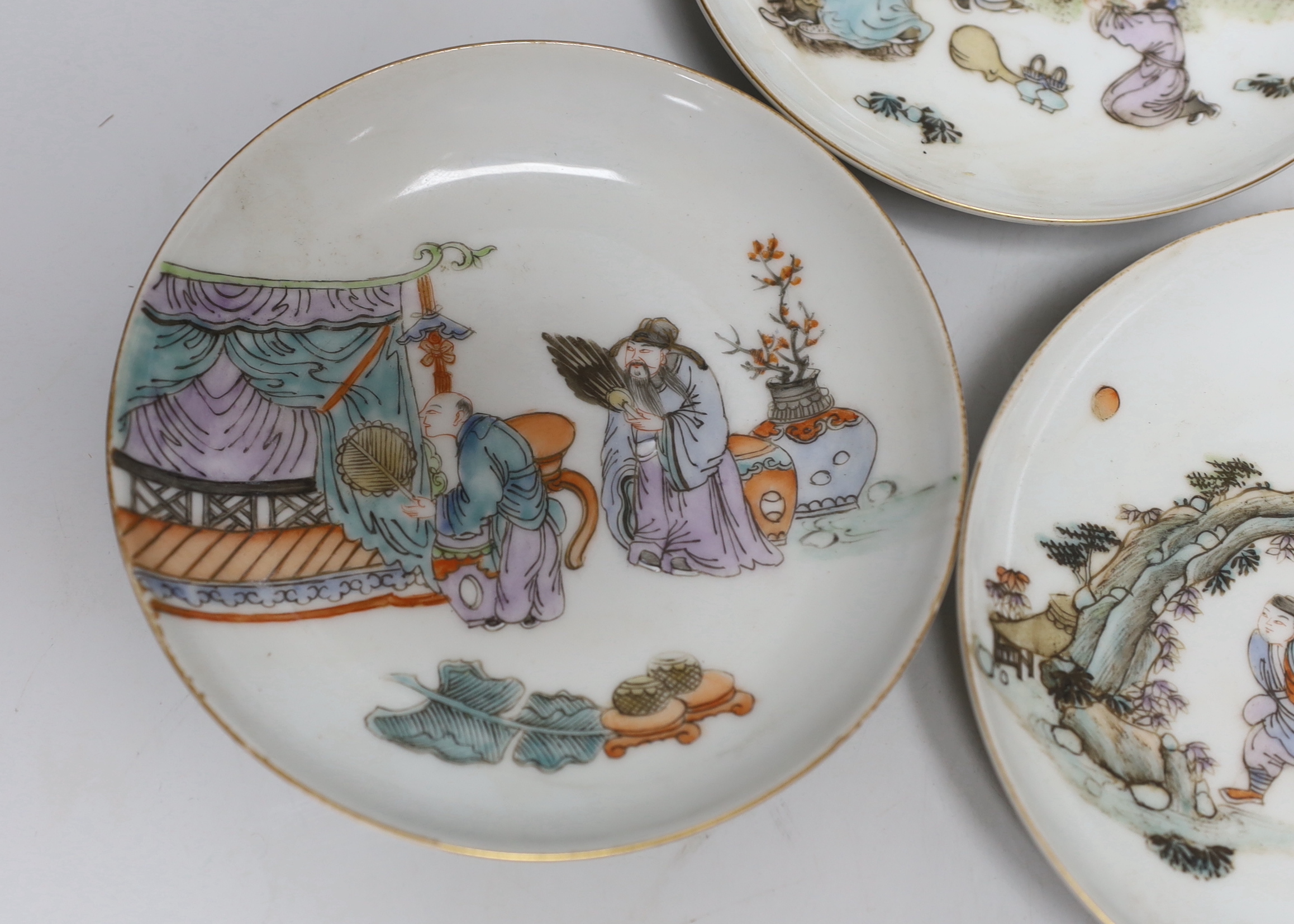 A set of five Chinese enamelled porcelain saucer dishes, decorated with figures and elders, each 13cm in diameter